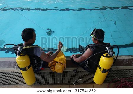 A Group Of People Doing Diving Training In A Swimming Pool In Batang / Central Java, Indonesia, Augu