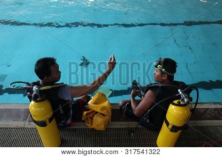 A Group Of People Doing Diving Training In A Swimming Pool In Batang / Central Java, Indonesia, Augu