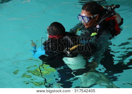 A Group Of People Doing Diving Training In A Swimming Pool In Batang / Central Java, Indonesia, Augu