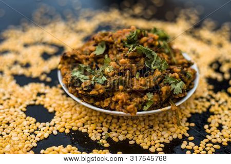 Famous Indian Punjabi Dish I.e. Roasted Dal With Spinach In A Glass Plate On The Wooden Surface Alon