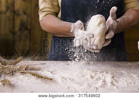 Womens Hands, Flour And Dough. Levitation In A Frame Of Dough And Flour. A Woman In An Apron Is Prep
