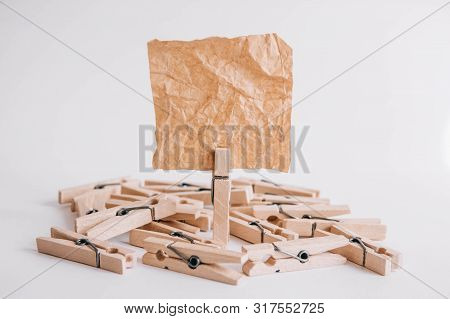 Woodenl Clothespins, Paper Clip And Brown Sticker On White Background. Isolated On White. Place For 