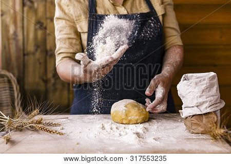 Womens Hands, Flour And Dough. Levitation In A Frame Of Dough And Flour. A Woman In An Apron Is Prep