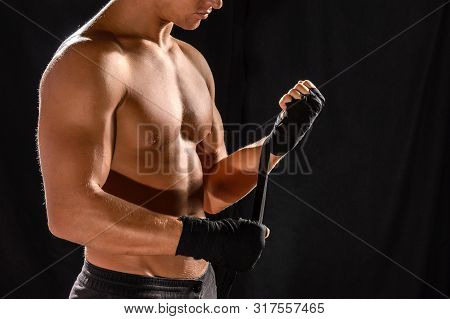 Half-length Portrait Of Hand Wrapping Half Nude Boxer, Isolated On Black