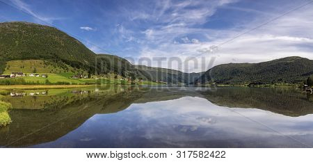 Panoramic View Over Lake Dalavatnet Near The Norwegian Town Sogndal On A Clear And Crisp Day