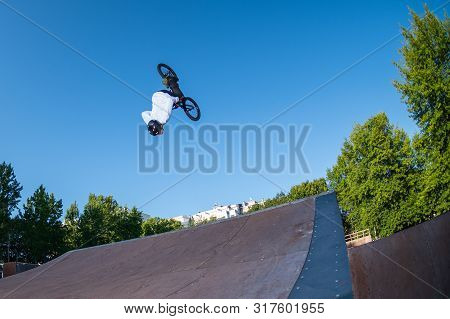 Biker Jump High From Jump Box Ramp Performing Dangerous Backflip Trick.