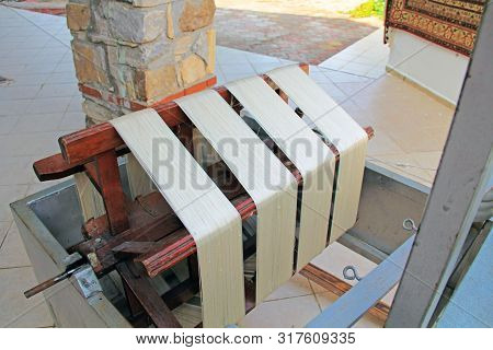 Spinning Wheel For Separating Fine Silk Threads From Cocoons In A Kibbutz In Turkey Near Selcuk.