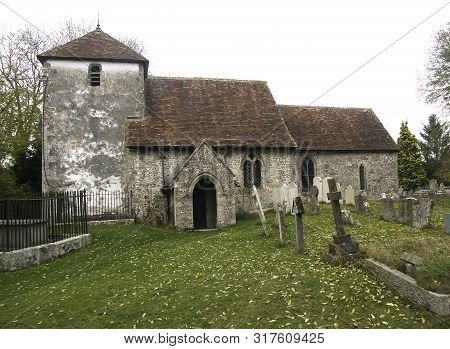 Landscape View Of St Mary-the-virgin Church In Winterbourne Gunner, Wiltshire, A Norman Stone Church