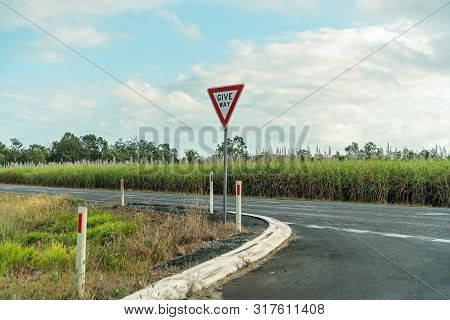 Give Way Sign To Car Driver When Entering The Highway At A Rural Intersection