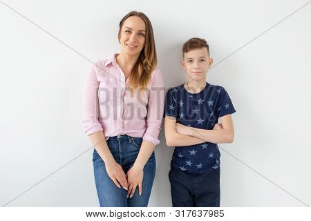 Good-looking Single-parent Mom And Teen Son On White Background. Cohesion, Friendship And Family Rel