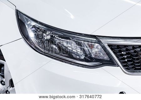 Novosibirsk, Russia - July 31, 2019:  Kia Rio, Close-up Of The White  Headlight, Bumper, Wheel. Phot