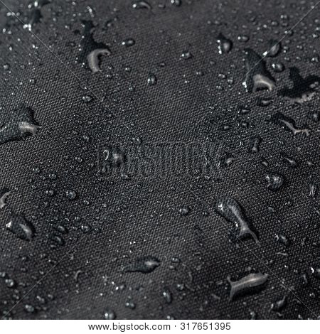 Dark Gray Waterproof Hydrophobic Cloth Closeup With Water Drops Selective Focus Background