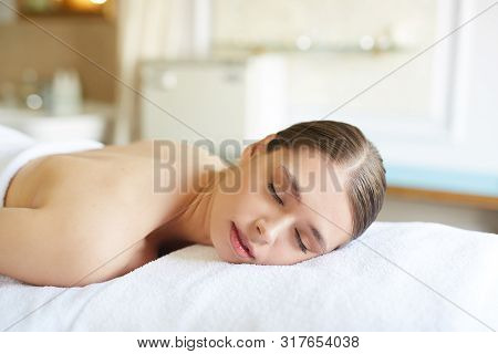 Closeup Portrait Of Beautiful Young Woman Lying On Massage Table With Eyes Closed While Relaxing In 