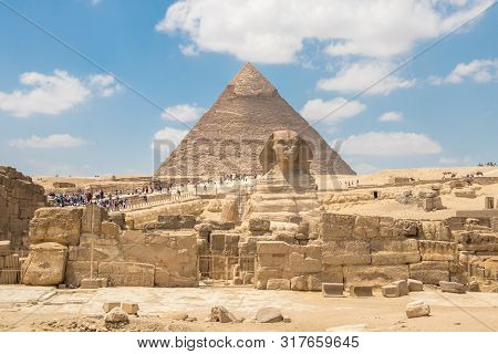 The Sphinx Monument With The Body Of A Lion And A Pharaoh's Head On Background Pyramid Of Chephren, 