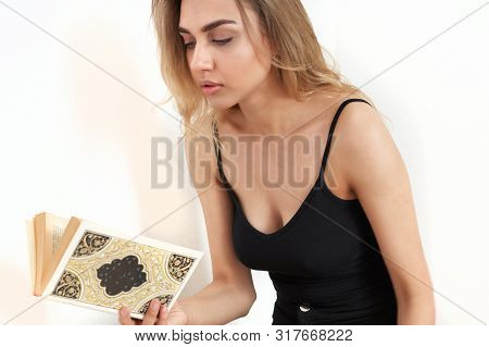 Beautiful Young Bondine With Her Hair Sitting On The Floor Is Reading A Book. Nearby Are Two Mobile 