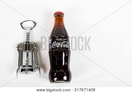 London, United Kingdom, 16th August 2019:- A Coca-cola Glass Bottle And Bottle Opener. Contains 10.6