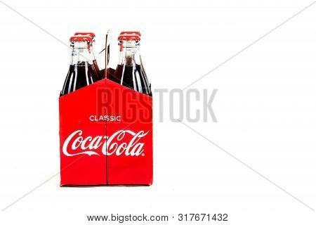 London, United Kingdom, 16th August 2019:- A Pack Of 4 Coca-cola Glass Bottles. Contains 10.6g Of Su