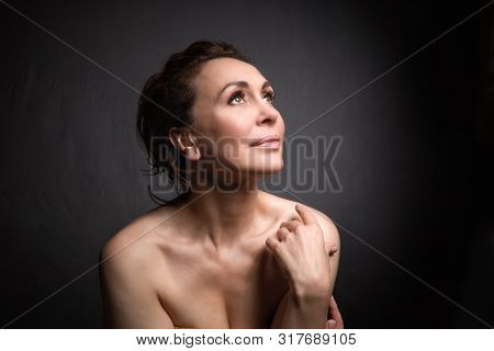 Portrait Of A Sensual Fifty Year Old Woman On Grey Studio Background