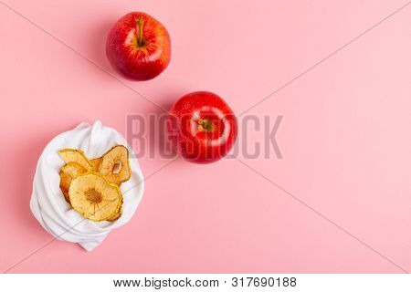 Homemade Sun-dried Organic Apple Slices, Crispy Apple Chips, On Pink Background With Fresh Apple.