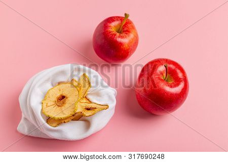Homemade Sun-dried Organic Apple Slices, Crispy Apple Chips, On Pink Background With Fresh Apple.