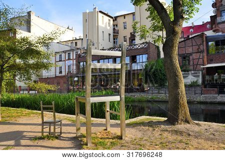 Bydgoszcz, Poland - August 15, 2019: Big And Small Chair On Mlynska Island, Promenade Along The Brda