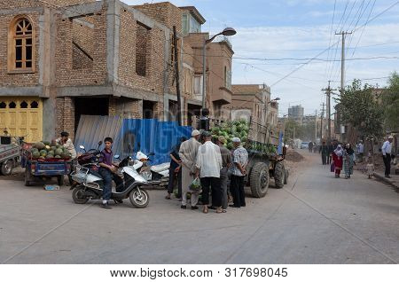 Kashgar, Xinjiang, China - August 14, 2012: People Buying Watermelons In A Street Market In The City