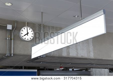 Public Clock And Blank Sign Board For Information In Railway Station At The Hanging With Roof Of Sub