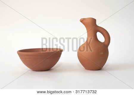 A Traditional Handmade Georgian Wine Jug And Clay Cup For A Red Wine Or Water On White Isolated Back