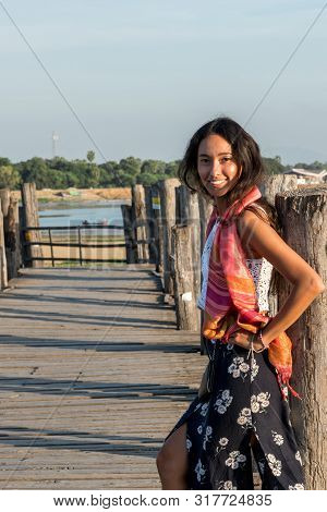 Vertical Picture Of Asian Eye Model Showing Hapiness At U Bein Bridge, A Landmark Of Mandalay, Myanm