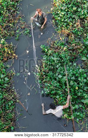 Mandalay, Myanmar - 03 December, 2018: From Top To Bottom Picture Of Local Burmese Fisherman Using A