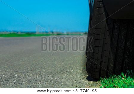 Car Wheel In Summerthe Wheel Of The Car In The Summer On The Road