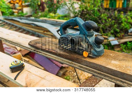 Blue Plane With Tape Measure On The Workbench
