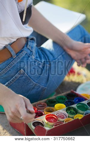 Girl Painter Holds A Brush