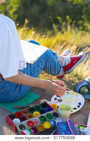 Girl Painter Holds A Brush