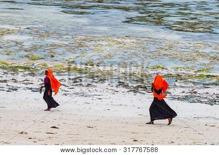 Stown Town, Tanzania - 11 January 2015: Local Girls Walk On Coast In Zanzibar