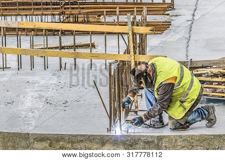 Welder  In Welding Steel Bars. Process By Shielded Metal Arc Welding (smaw) .
