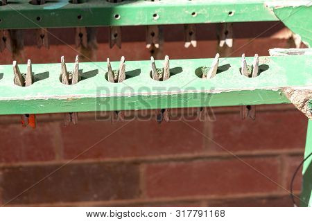 A Close Up Of Woodern Pegs That Are Used To Hold Wet Paper Painting At A School