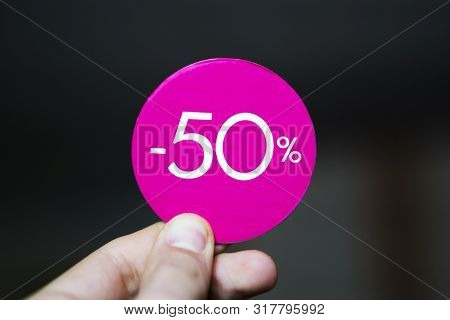 Sale 50 Persent Red Tag In Hand. Discount Label Sticker Hold In Finger Background.