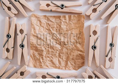 Woodenl Clothespins, Paper Clip And Brown Sticker On White Background. Isolated On White. View From 