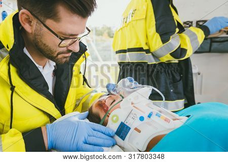 Medic taking care of injured woman with whiplash collar in ambulance