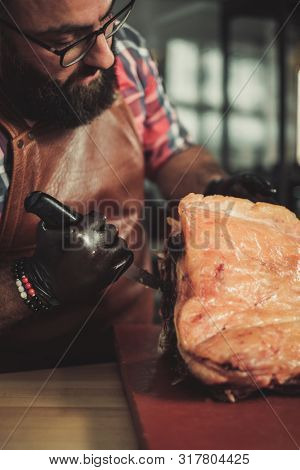 Chef cutting beef carcass in a restaurant