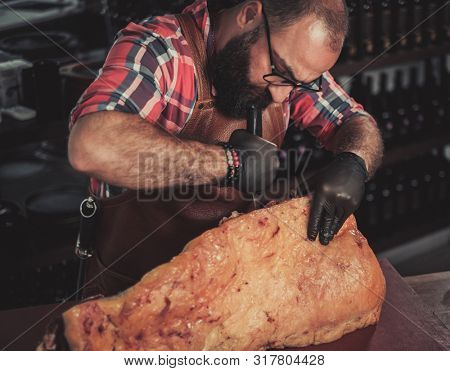Chef cutting beef carcass in a restaurant