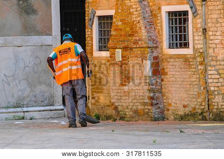 Venice, Italy - July, 11, 2019: Yard-keeper in Venice, Italy