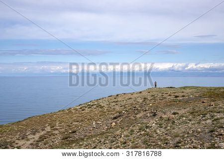 A Man Standing On A Hill And Looking At Issyk-kul Lake And Ala-too Mountains. Kyrgyzstan
