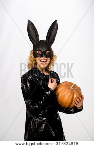 Halloween Costume. Woman In Black Bunny Mask With Pumpkin. Smiling Woman In Halloween Bunny Costume.