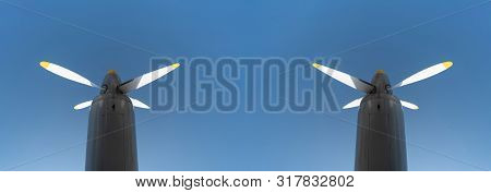 Two Airplane Propeller Of Military Aircraft, Copy Space. Blue Sky Background.