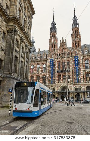 Citylife With People And Tram Passing The City Of Amsterdam Netherlands