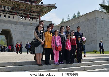 Pyongyang, North Korea - May 1, 2019: People Relax In The Public Park Taesongsan Funfair. Big Family