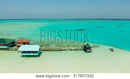 Seascape With Beautiful Beach And Tropical Island Surrounded By A Coral Reef From Above. Onok Island