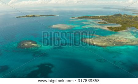 Islands Are Surrounded By An Atoll And A Coral Reef With Blue Water Top View. Bucas Grande, Philippi